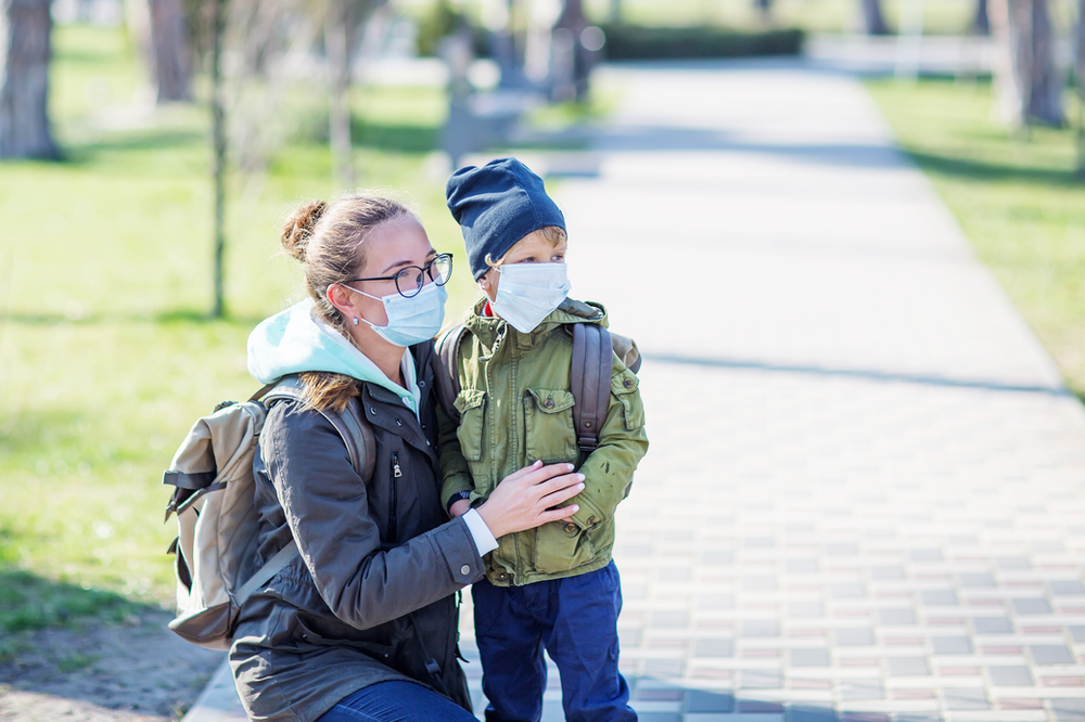 Parent and child wearing masks outdoors